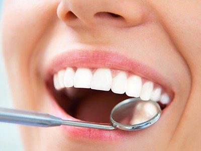 Close up of dental mirror inside of mouth