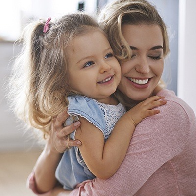 Mother hugging daughter