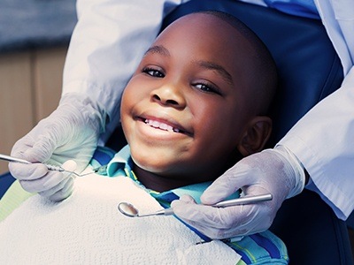 Smiling young boy getting dental checkup