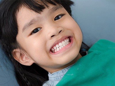 Young girl grinning in dental chair