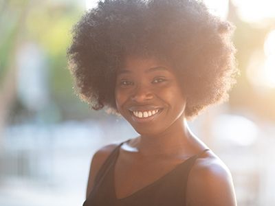 A person walking outside and smiling