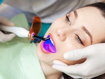 Young woman getting cosmetic bonding from dentist