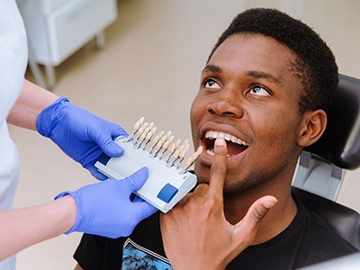 man pointing to tooth