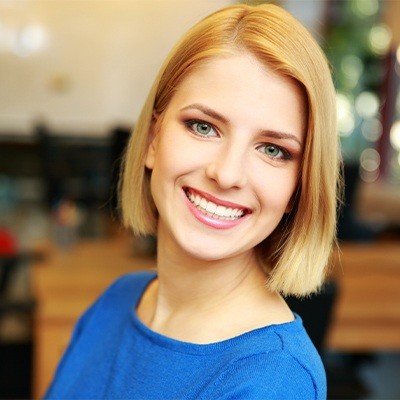 Blonde woman smiling with dental crowns in Fort Worth