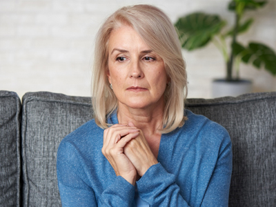 A pensive woman sitting on a couch