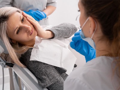 : A woman receiving treatment for a dental emergency