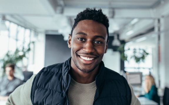 Man in vest smiling