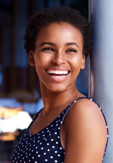 Woman in polka dot tanktop laughing