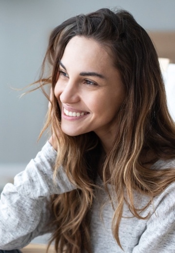 Woman in light gray blouse smiling