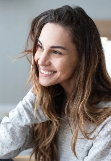 Woman in light gray blouse smiling