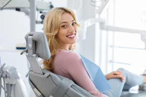 Patient smiling while sitting in treatment chair