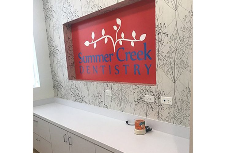 Red sign in dental office that reads Summer Creek Dentistry