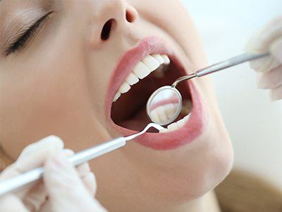 Woman getting her mouth examined by dentist