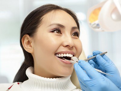 Woman getting her mouth examined by dentist