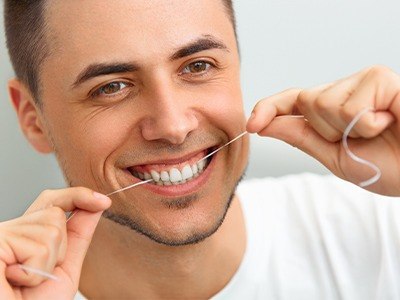 Man flossing his teeth