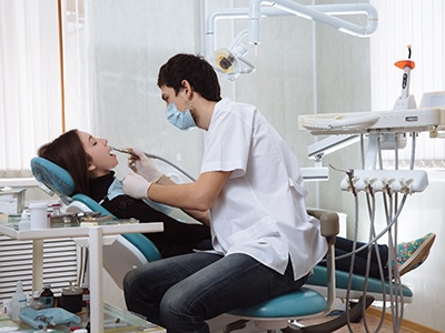 Woman at dentist receiving root canal procedure