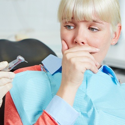 Dental patient covering her mouth before sedation dentistry in Fort Worth