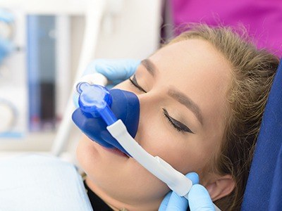 Woman in dental chair with nitrous oxide mask on
