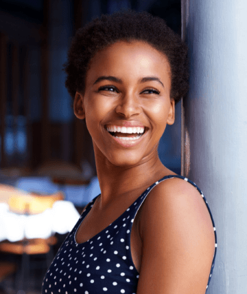 Woman in polka dot tank top laughing