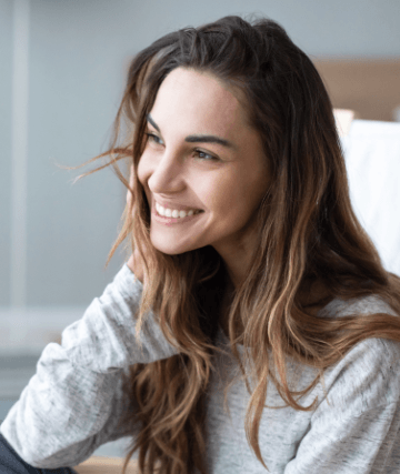 Woman in light gray blouse smiling