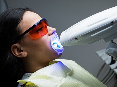 Woman getting professional in office teeth whitening