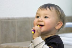 A young child brushing their teeth.