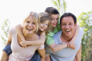 Happy family smiling outdoors