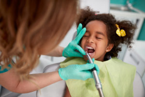 Child having teeth polished at the dentist