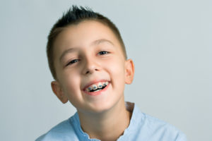 little boy smiling with braces