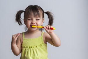 Young girl brushing her teeth.