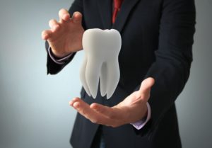 man holding a tooth