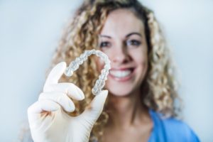 doctor holding invisalign tray