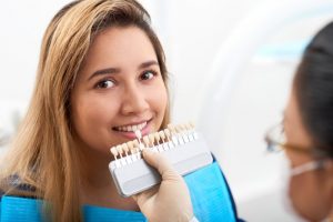 young woman replacing veneers at her dentist’s office 