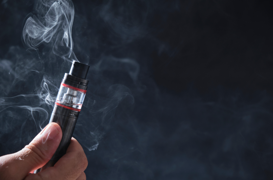 Close up of a hand holding a vape